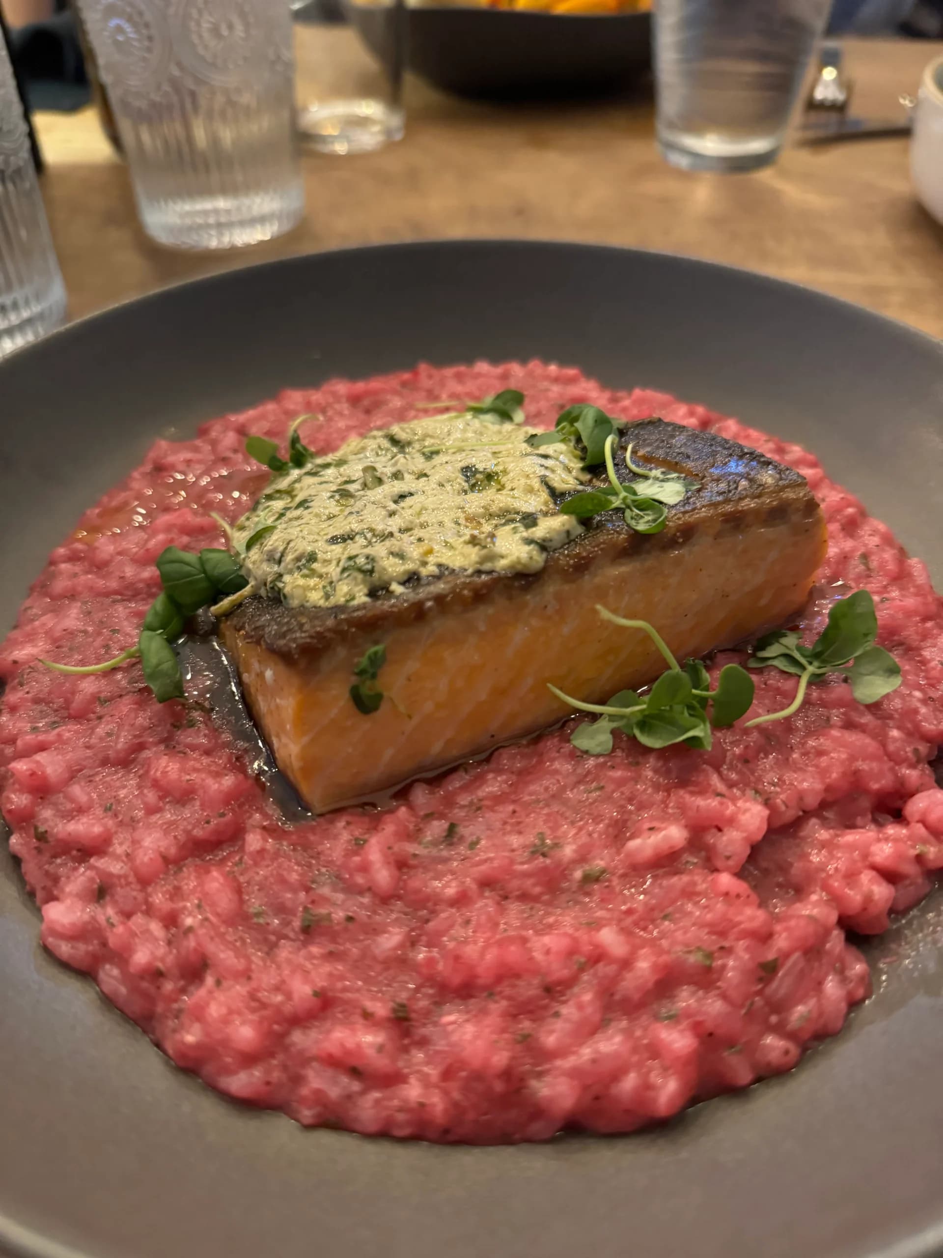 Salmon with herb butter rests on a striking pink risotto at Sugo on Surrey.